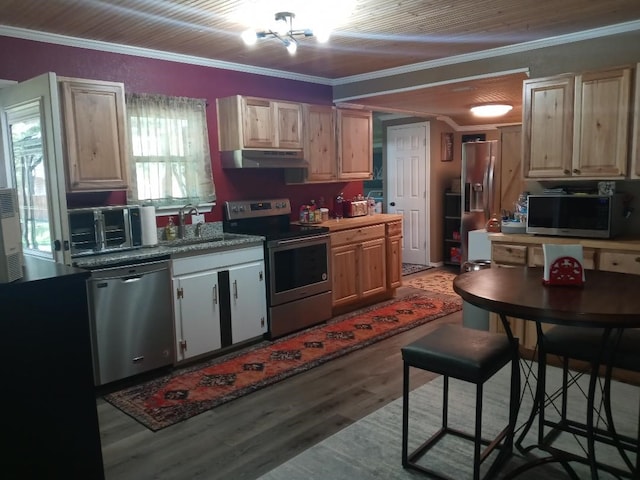 kitchen featuring light wood-type flooring, appliances with stainless steel finishes, ornamental molding, and sink