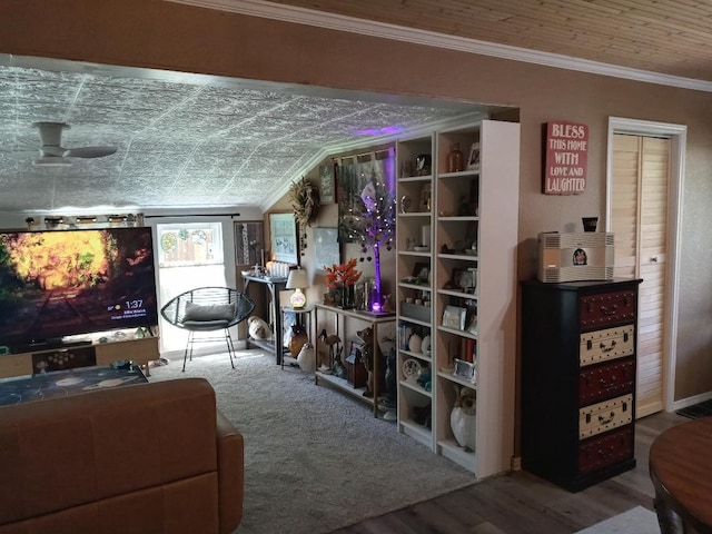 living room with ceiling fan, ornamental molding, lofted ceiling, and wood-type flooring