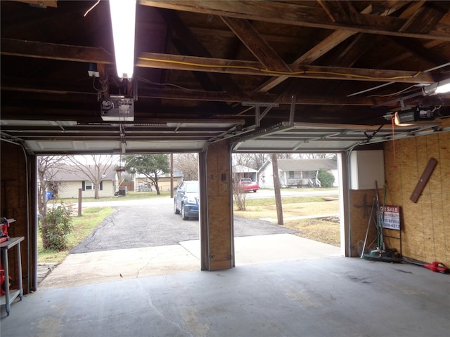 garage featuring a garage door opener and a carport