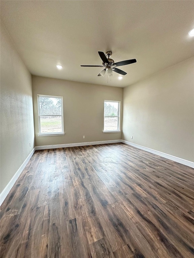 empty room with ceiling fan and dark hardwood / wood-style floors