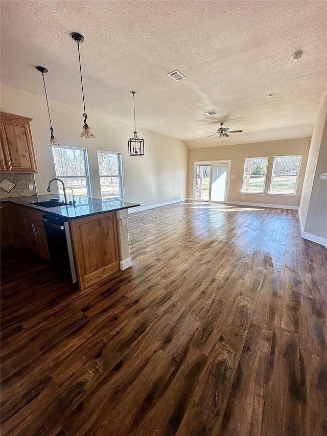 kitchen with pendant lighting, black dishwasher, dark hardwood / wood-style flooring, tasteful backsplash, and sink