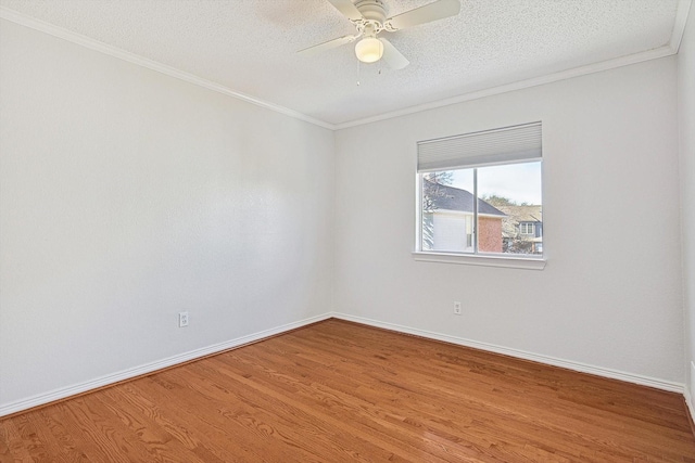 unfurnished room featuring hardwood / wood-style flooring, ornamental molding, ceiling fan, and a textured ceiling