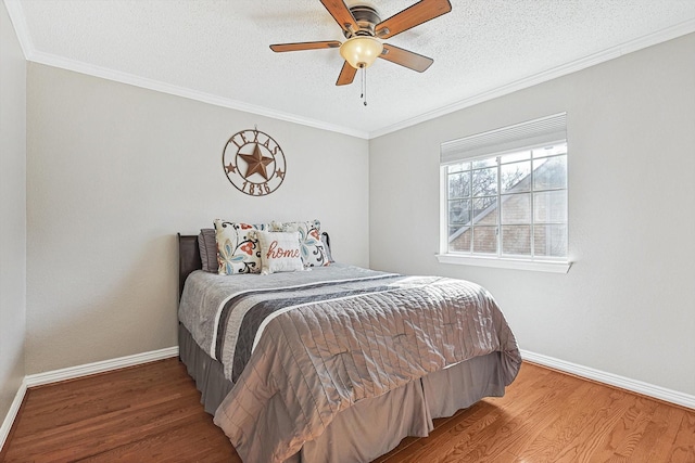 bedroom featuring hardwood / wood-style flooring, crown molding, and a textured ceiling