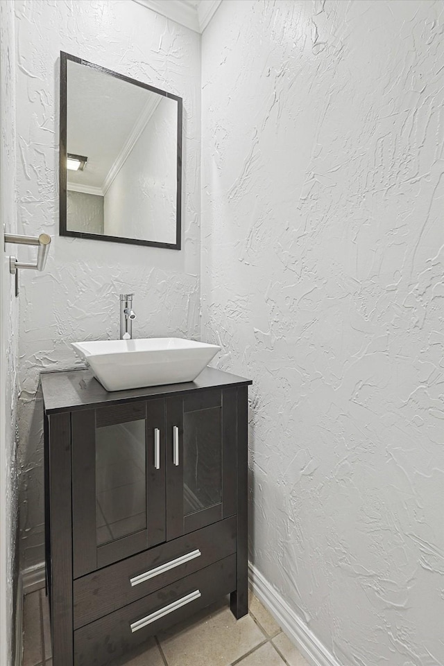 bathroom with ornamental molding, vanity, and tile patterned floors