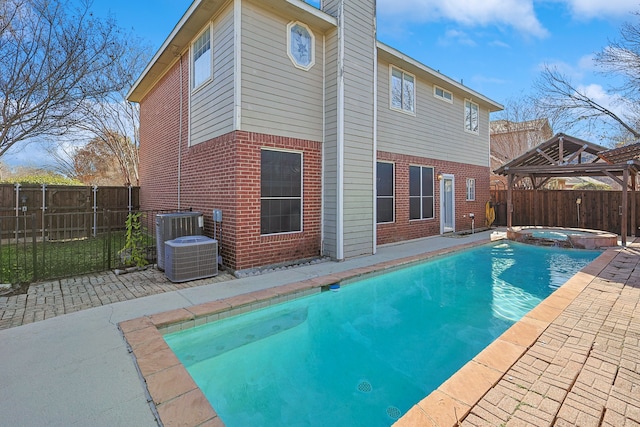 view of pool with an in ground hot tub, a patio, a gazebo, and cooling unit