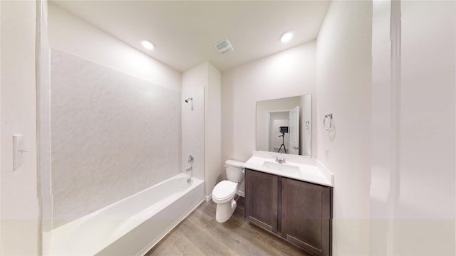 full bathroom with toilet, vanity,  shower combination, and hardwood / wood-style flooring