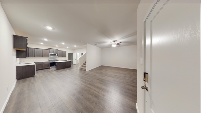 living room featuring ceiling fan and hardwood / wood-style floors