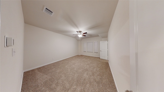 empty room with ceiling fan and light colored carpet