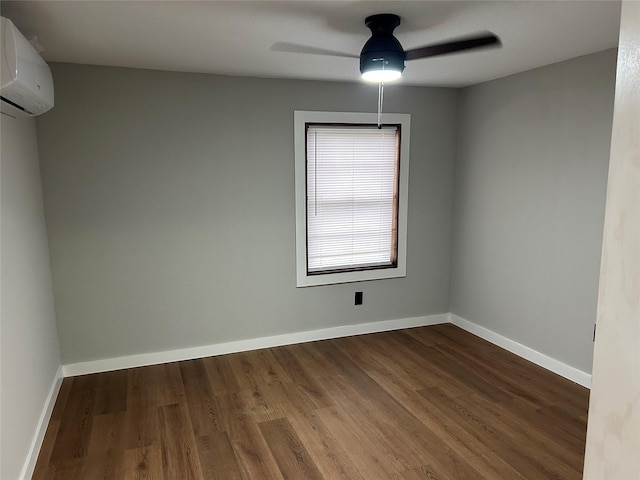 empty room with ceiling fan, a wall mounted AC, and wood-type flooring