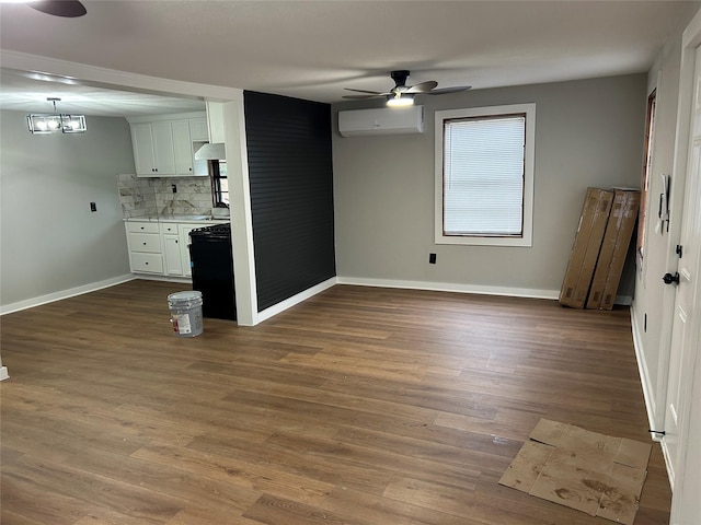 kitchen with a wall mounted AC, decorative backsplash, dark hardwood / wood-style floors, ceiling fan with notable chandelier, and white cabinets