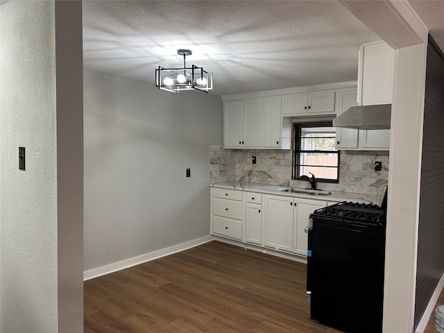 kitchen with white cabinetry, tasteful backsplash, a chandelier, black range with gas stovetop, and sink