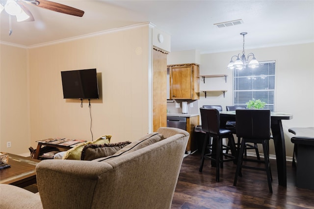 living room featuring dark hardwood / wood-style floors, ceiling fan with notable chandelier, and ornamental molding