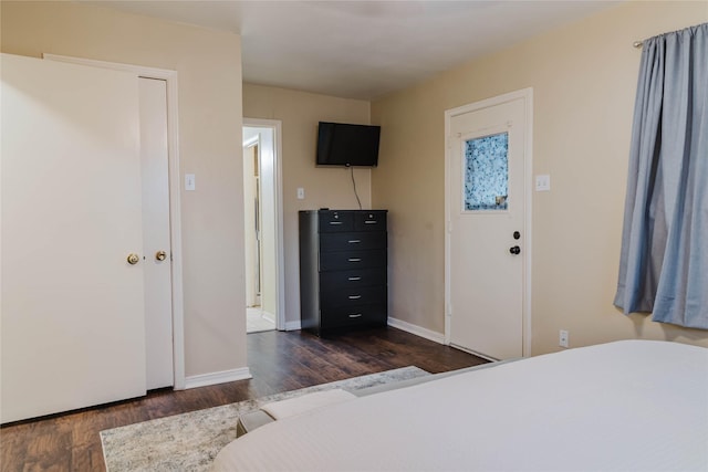 bedroom with dark wood-type flooring