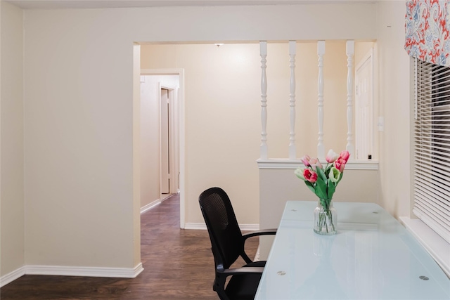 home office with dark hardwood / wood-style flooring