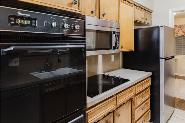 kitchen featuring black appliances and light tile patterned floors