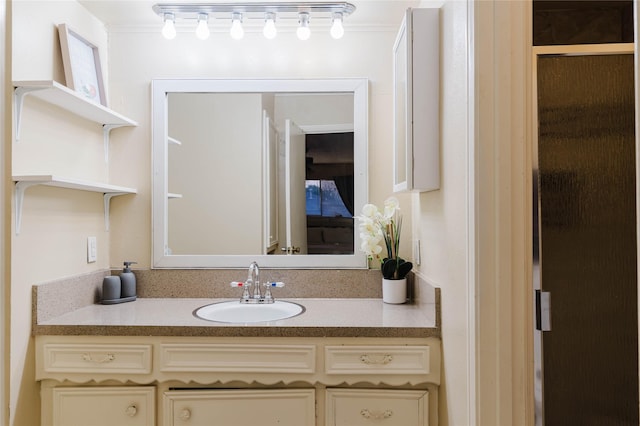 bathroom featuring a shower with door, vanity, and ornamental molding