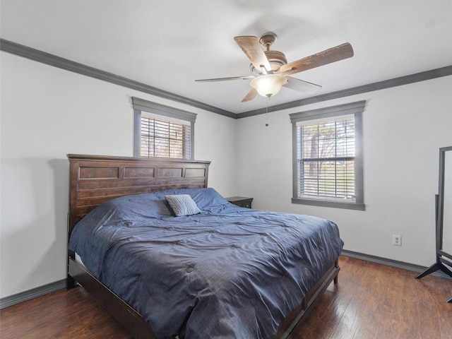 bedroom with ceiling fan, multiple windows, dark hardwood / wood-style flooring, and ornamental molding