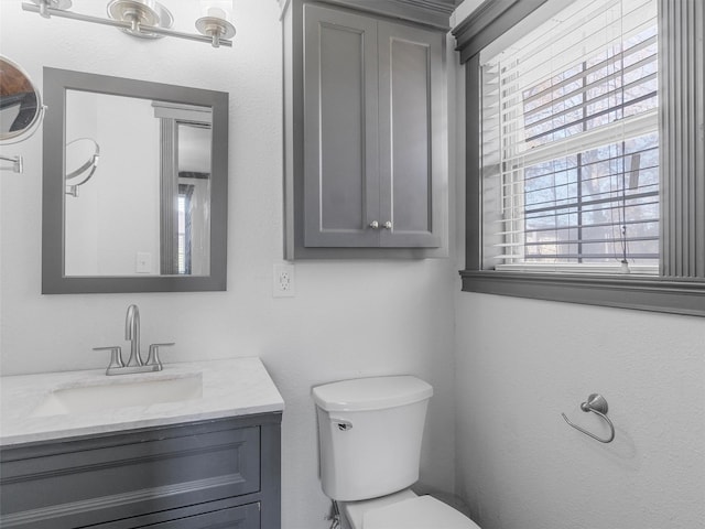 bathroom featuring toilet and vanity