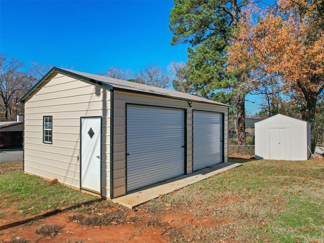 view of outbuilding with a garage and a yard