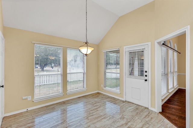 unfurnished dining area featuring lofted ceiling