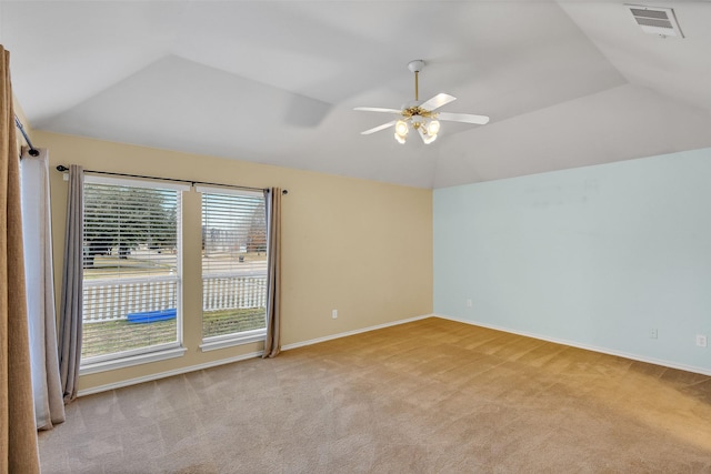 unfurnished room featuring light carpet, vaulted ceiling, and ceiling fan