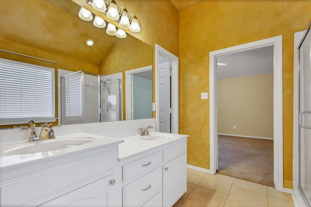 bathroom featuring vanity, vaulted ceiling, tile patterned floors, and a shower with shower door