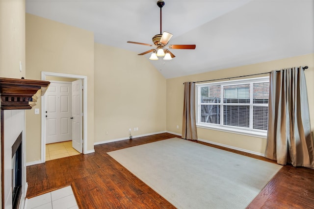 unfurnished living room featuring ceiling fan, lofted ceiling, and light wood-type flooring