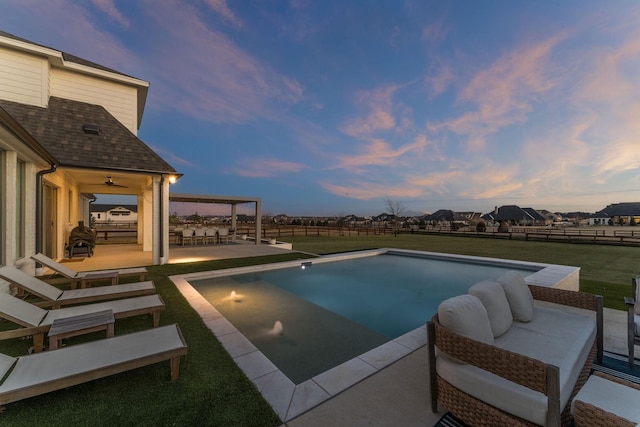 outdoor pool with fence, an outdoor living space, a ceiling fan, and a yard