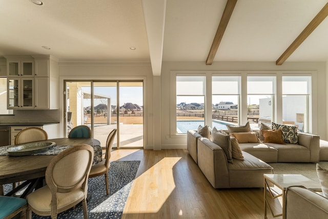 living area featuring light wood-style floors and beam ceiling