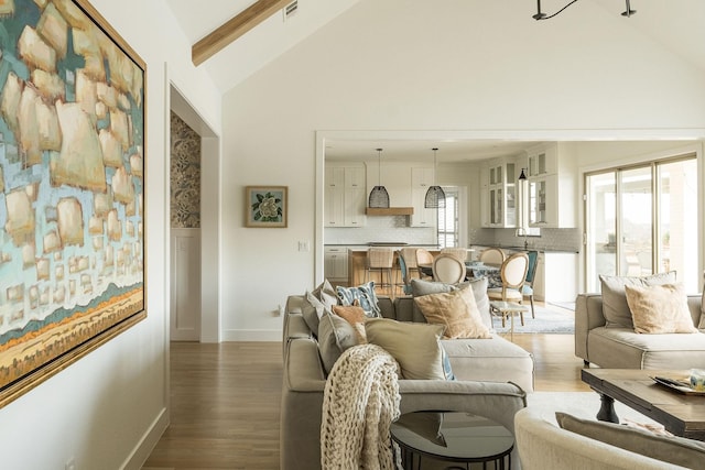 living room with high vaulted ceiling, dark hardwood / wood-style flooring, and beam ceiling