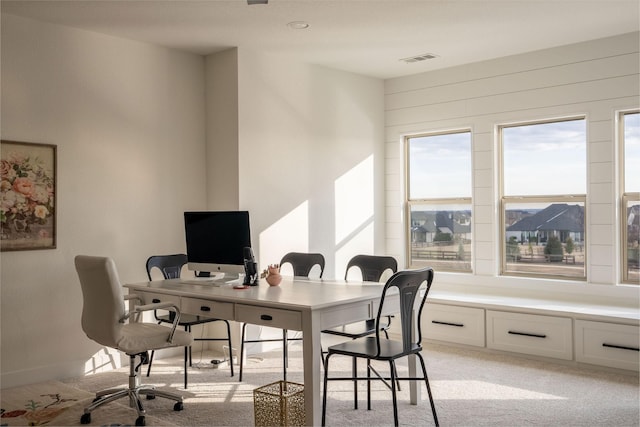 office area featuring light carpet, baseboards, and visible vents