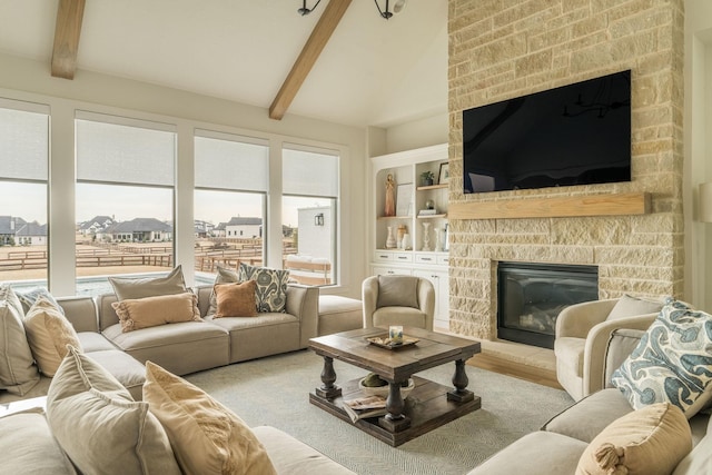 living room featuring a stone fireplace, wood finished floors, lofted ceiling with beams, and built in features