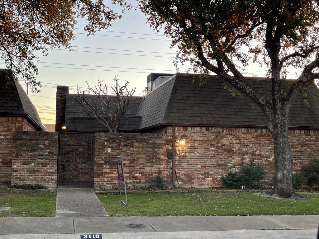 property exterior at dusk with a yard