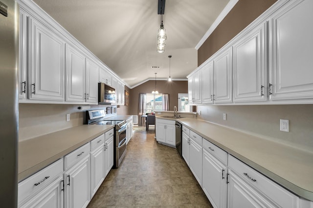 kitchen with appliances with stainless steel finishes, white cabinetry, and pendant lighting