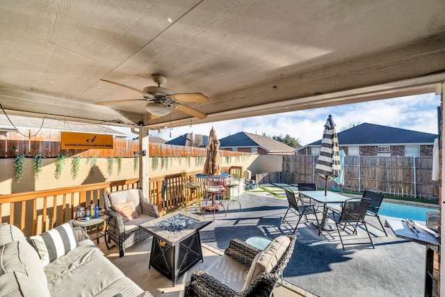 view of patio / terrace with ceiling fan and an outdoor fire pit