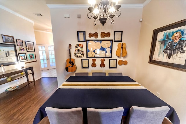 dining room with french doors, dark hardwood / wood-style flooring, crown molding, and a notable chandelier