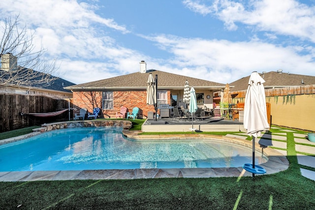 view of swimming pool with a patio