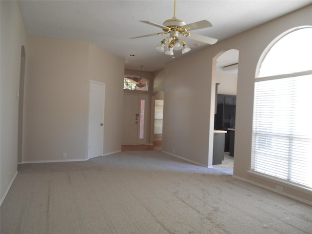 carpeted spare room featuring ceiling fan