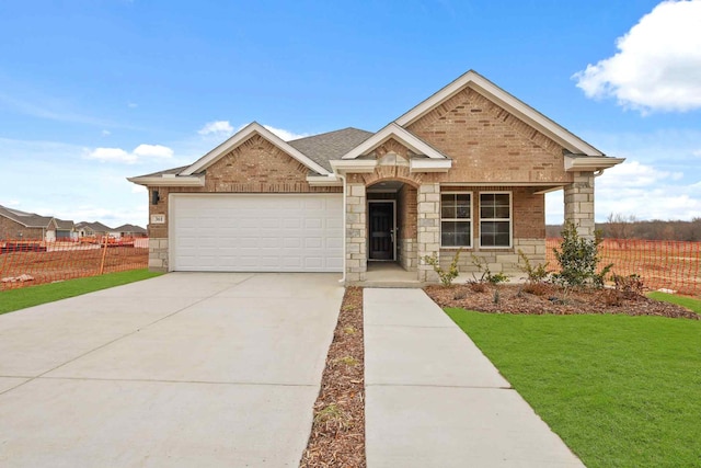 view of front of property featuring a garage and a front yard