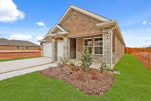 view of front of property with a garage and a front lawn