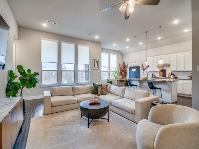 living room featuring ceiling fan and light wood-type flooring