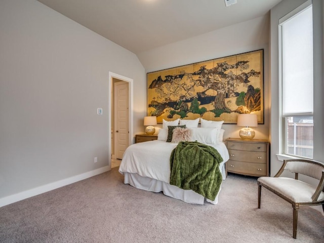 carpeted bedroom with lofted ceiling