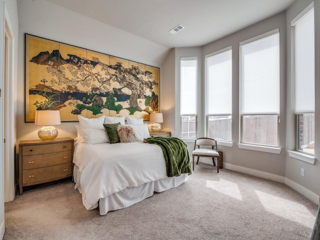 carpeted bedroom with lofted ceiling