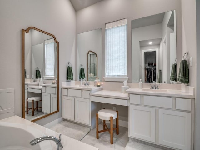 bathroom featuring a tub to relax in and vanity