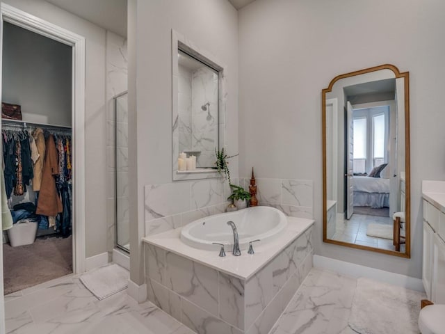 bathroom featuring vanity and separate shower and tub