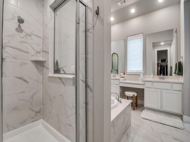 bathroom featuring vanity and independent shower and bath