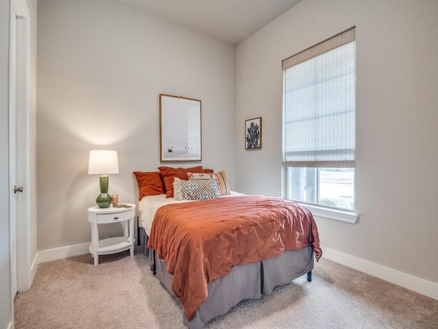 bedroom featuring light colored carpet