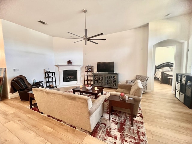 living room featuring ceiling fan and light hardwood / wood-style flooring