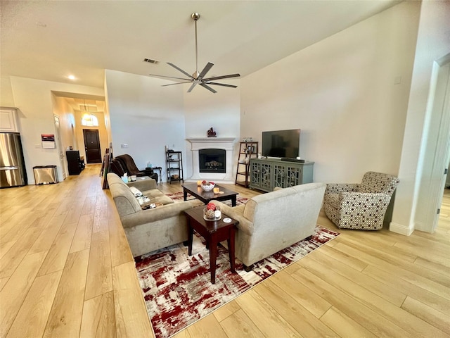 living room with ceiling fan and light wood-type flooring