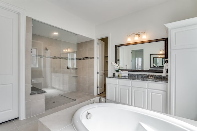 bathroom featuring tile patterned flooring, separate shower and tub, and vanity